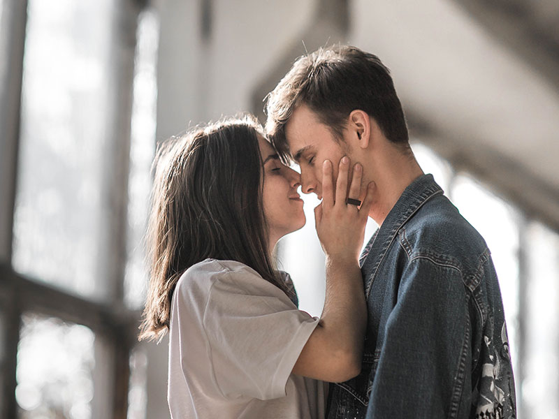 A girl kissing her date and wondering how many dates before it's a relationship.