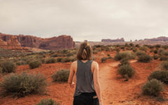 A woman who read these letting go quotes walking through the desert towards the future.