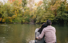 A couple dating after divorce at 40 leaning against each other as they look at a beautiful lake.