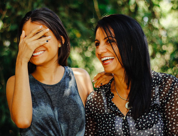 A woman dating over 50 laughing with her adult child.