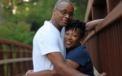 A women who was dating single men over 50, hugging her boyfriend on a deck in the woods.