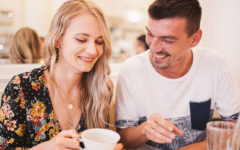 A couple chatting and laughing over coffee as they establish good communication in their relationship.