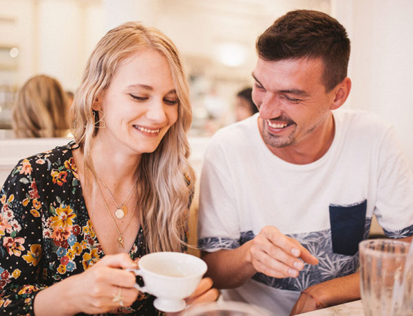 A couple chatting and laughing over coffee as they establish good communication in their relationship.