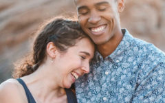 A happy couple who learned how to give and get respect in a relationship laughing in the sunshine as they hug each other.
