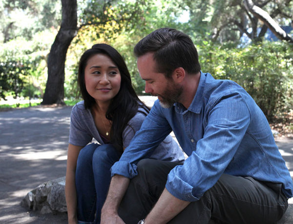 A guy who learned how to start a conversation with a girl chatting with a woman who's interested in what he has to say.