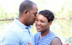 A man and a woman on a date, smiling as they hug each other.