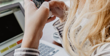 A woman using these dating profile tips to update her profile.