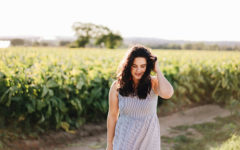 A woman who's letting go of love, walking in a field and reflecting on her time alone.