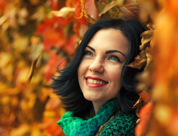 A woman who learned how to break up with someone in a mature way, smiling and happy now that she feels stronger after the breakup.