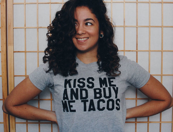 A girl smiling and waiting for a guy to figure out "should I ask her out?"