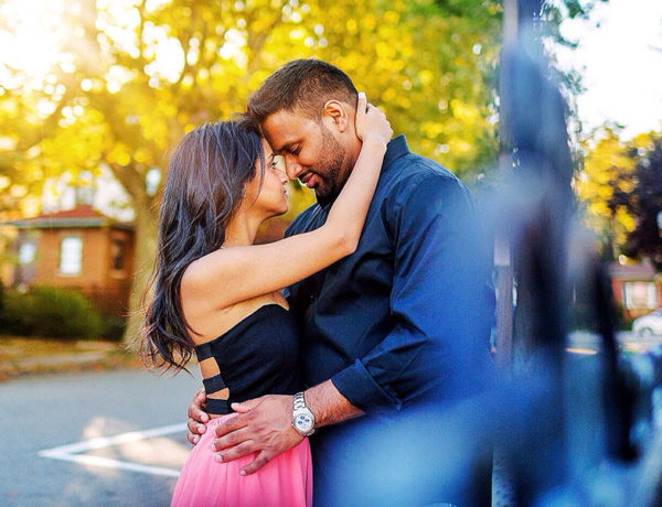 A woman who's trying to deal with emotionally unavailable men, hugging her boyfriend and caressing his face.