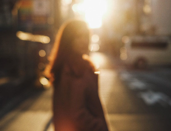 Someone getting through a divorce while still in love watching their spouse walk away in a crowded street.