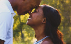 A couple laughing as they lean their foreheads together because they've found the one.