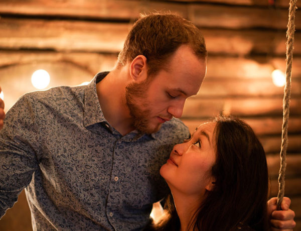 A woman who's wondering what is casual dating, looking up at her date longingly.