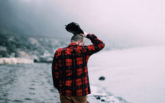 An emotionally unavailable man walking down a foggy beach and thinking.
