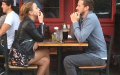 A couple calmly having an argument at a coffee shop.