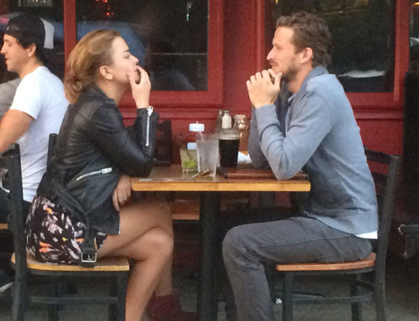 A couple calmly having an argument at a coffee shop.