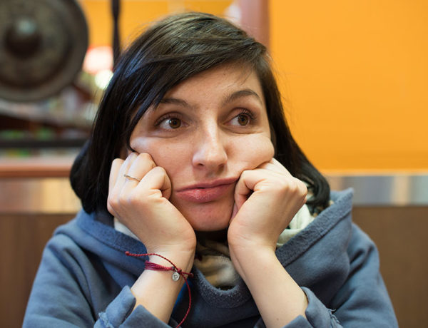 A woman who's bored at a restaurant, wondering if she's going to be single forever.