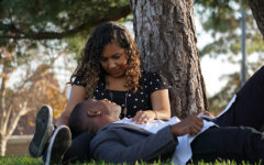 A couple who knows how to be good at communication in relationships, chatting outside in the grass.