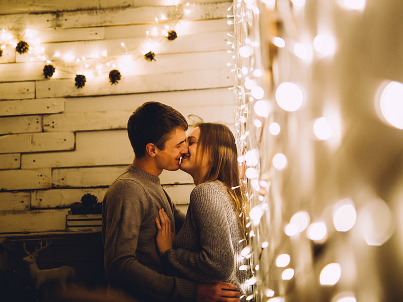 A couple who are fwb dating, making out in the corner of an outdoor party.