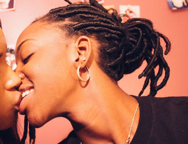 A woman who identifies as bi-curious, moving in to kiss another woman.