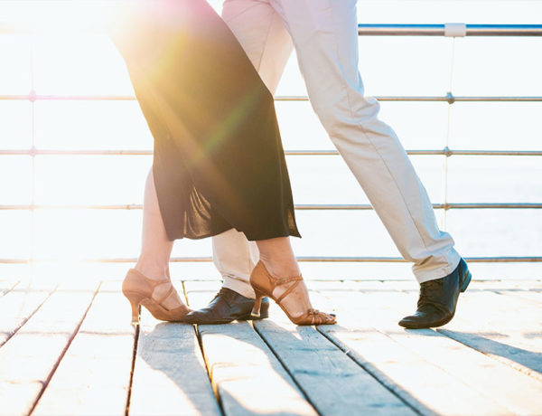 A man who was looking where to meet women, dancing with a woman at a dancing class.