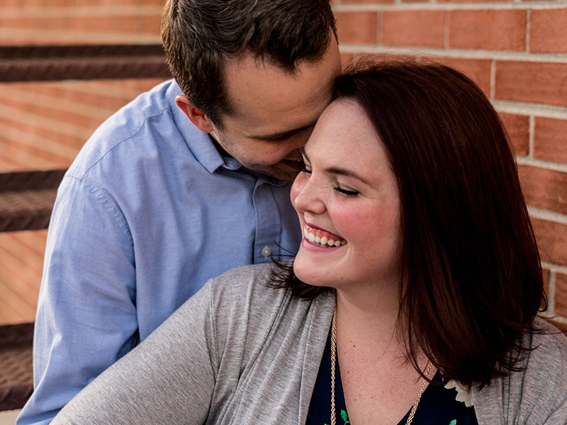 A couple dating in middle age hugging and laughing together.