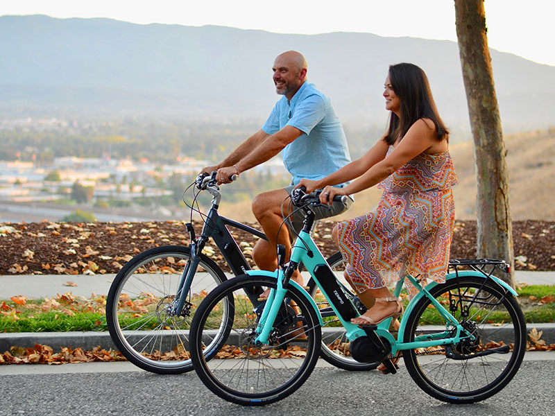 A man dating a single mom, riding bikes with her on their date together.