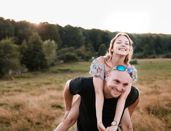 A guy who learned how to be a good boyfriend giving his girlfriend a piggy back ride.