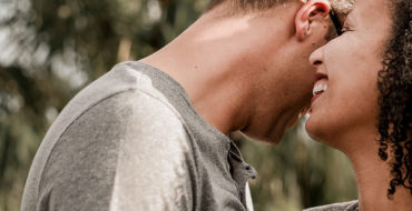 A couple dating over 50 laughing together outside on a date.
