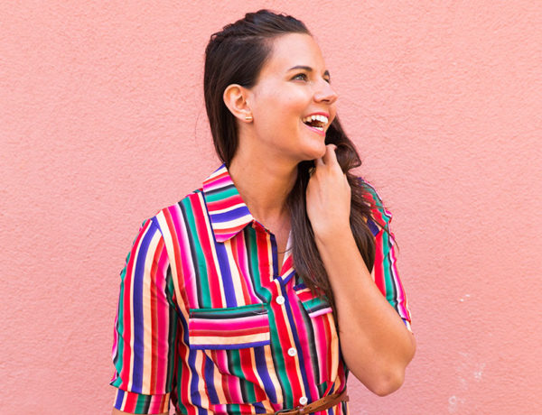 A woman laughing and being happy, showing one of the qualities of a good woman.