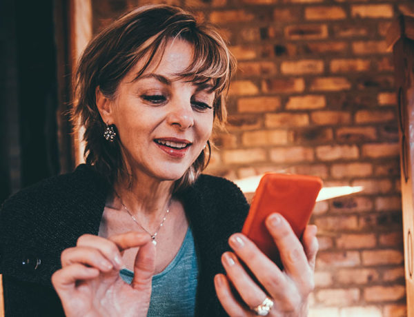 A woman trying to find the best dating websites while searching on their phones.
