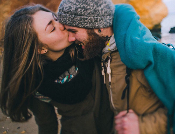 A girl and a guy who used to have bad dating experiences, laughing and kissing on the beach.