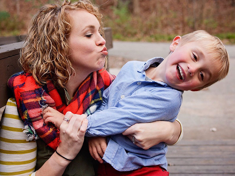 A mom who's learning how singles parents dating do it, trying to kiss her son as he laughs and pulls away.