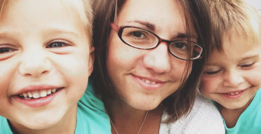 A woman who knows all about these tips for dating a single mom smiling with her two sons in her backyard.