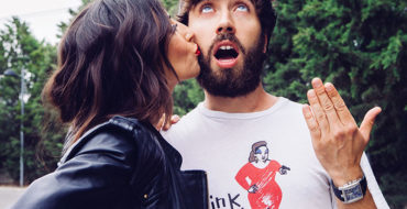 A couple having a memorable first date while a girl kisses a guy's face, who's being silly.