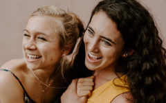 Two friends who met on Bumble BFF laughing and hugging together.