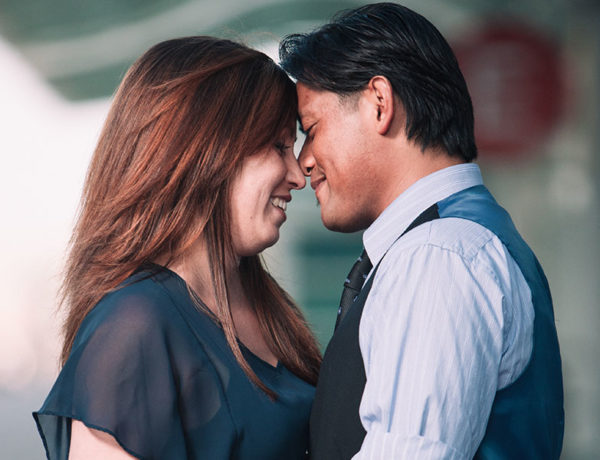 A man who's hugging his girlfriend and showing all the signs a man is falling in love with you.