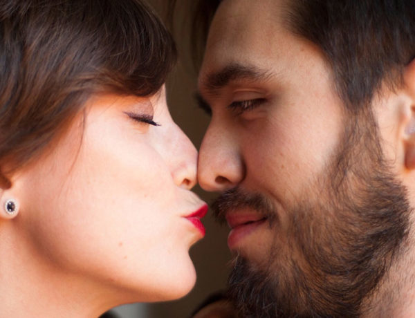A couple about to kiss with their eyes closed, showing one of the different ways to say I love you.