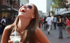 A girl laughing really hard after a guy asked her one of these flirty questions to ask a girl.