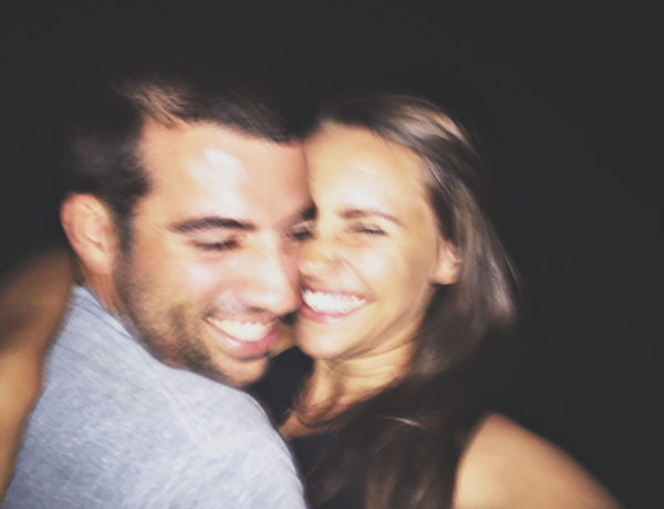 A guy wondering how to tell a girl you like her, while laughing and smiling as he takes a selfie with his friend.