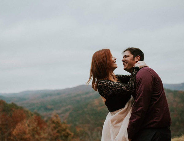 A woman who learned how to tell him you love him, hugging her boyfriend and looking into his eyes before kissing him.