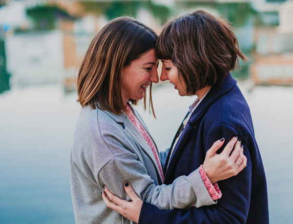 A couple looking into each other's eyes and smiling because they feel these signs of true love.
