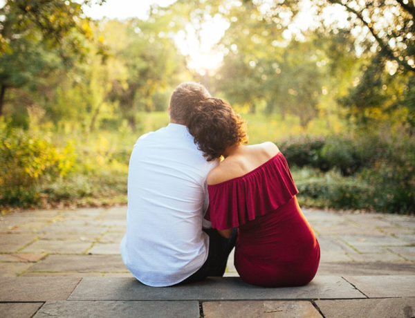 A couple leaning against each other and wondering, "Is love real?"