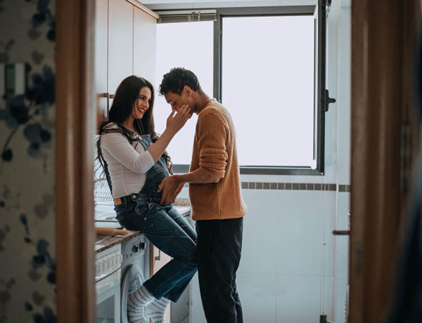 A couple who have experienced many of the different types of love, embracing as the woman is pregnant and the man holds her belly.