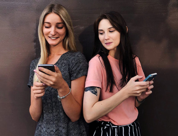 Two girls who are using these Tinder hacks to meet people on the app.