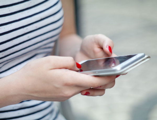 A women using some of these Tinder opener strategies to start a conversation with a man on the app.