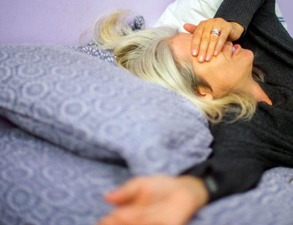 A woman who's divorcing a narcissist looking stressed out and upset.