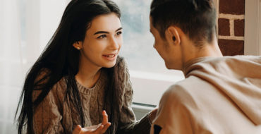 A girl saying a few of these things cheaters say to her boyfriend while arguing in a cafe.