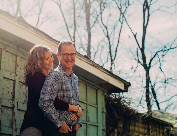 A man and a woman hugging. Both of them look happy and confident.